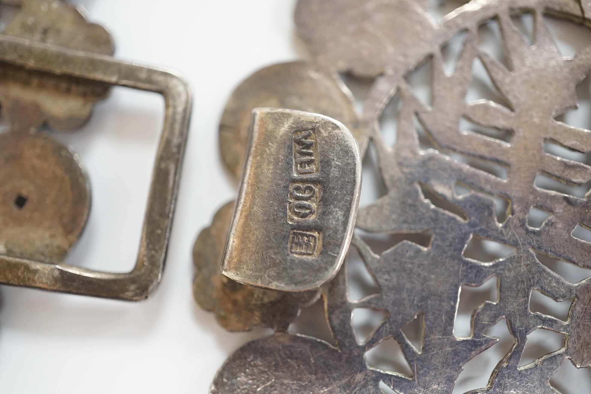 A late 19th/early 20th century Chinese Export pierced white metal 'Shou and Fu' belt buckle, by Wang Hing, width 10.3cm. Condition - fair to good